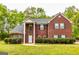 Classic brick residence with a symmetrical facade, dark shutters, and lush green landscaping at 1015 Middlebrook Dr, Mcdonough, GA 30252