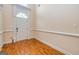Bright entryway with hardwood floors, white trim, and a door featuring a semi-circular window at 1015 Middlebrook Dr, Mcdonough, GA 30252