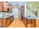 Updated kitchen featuring granite countertops, wood cabinets and floors, and stainless appliances at 1015 Middlebrook Dr, Mcdonough, GA 30252