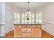 Kitchen island with granite countertops and wooden cabinets, bathed in natural light at 1015 Middlebrook Dr, Mcdonough, GA 30252
