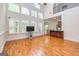 Spacious living room with tall windows, hardwood floors, and an open view to the kitchen at 1015 Middlebrook Dr, Mcdonough, GA 30252