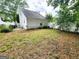 The backyard is partially fenced and grassy at 645 Crossbridge Aly, Johns Creek, GA 30022
