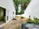 The backyard features a side patio, small fountain, white siding, and backyard access at 645 Crossbridge Aly, Johns Creek, GA 30022