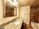 Bathroom with granite vanity top, decorative tiling in the shower, framed mirror and white fixtures at 645 Crossbridge Aly, Johns Creek, GA 30022