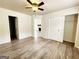 Open and bright bedroom with walk-in closet, hardwood floors, and neutral color scheme at 645 Crossbridge Aly, Johns Creek, GA 30022
