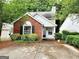 Charming home featuring brick accents, manicured landscaping, and inviting curb appeal in a tranquil neighborhood setting at 645 Crossbridge Aly, Johns Creek, GA 30022