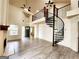 A spacious living room with a fireplace and a unique spiral staircase at 645 Crossbridge Aly, Johns Creek, GA 30022
