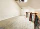 Second floor loft area features vaulted ceilings, neutral carpeting, and railing at 645 Crossbridge Aly, Johns Creek, GA 30022