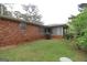 A view of the home's brick exterior and a grassy backyard at 3257 Greenvale Way, Decatur, GA 30034