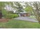 A single-story brick house surrounded by lush greenery, featuring a driveway and well-kept lawn at 3257 Greenvale Way, Decatur, GA 30034