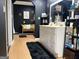 Modern black bathroom with a dual sink vanity, bench seating, and stylish decorations at 4710 Meadowlark Se Dr, Conyers, GA 30094