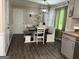 Stylish dining area with a bench and chair set, wood-look flooring and modern light fixture at 4710 Meadowlark Se Dr, Conyers, GA 30094