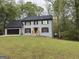 Charming gray two-story home with black shutters and a spacious front yard at 4710 Meadowlark Se Dr, Conyers, GA 30094