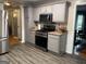 Spacious kitchen features stainless appliances, gray cabinets, and hardwood-style flooring at 4710 Meadowlark Se Dr, Conyers, GA 30094