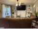 Cozy living room featuring a fireplace, built-in bookshelves, and a comfortable brown sectional couch at 4710 Meadowlark Se Dr, Conyers, GA 30094