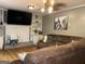 Inviting living room with a fireplace, built-in shelving, and a comfortable brown sectional couch at 4710 Meadowlark Se Dr, Conyers, GA 30094
