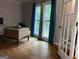 Bright home office with hardwood floors, natural light, and a modern desk and chair setup at 4710 Meadowlark Se Dr, Conyers, GA 30094