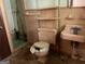 Dirty bathroom featuring a toilet, sink, shower and a tiled wall at 8395 Rivertown Rd, Fairburn, GA 30213