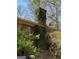 Chimney with ivy on a brick home, surrounded by trees at 8395 Rivertown Rd, Fairburn, GA 30213