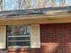 Exterior brick home with damaged roof and window at 8395 Rivertown Rd, Fairburn, GA 30213