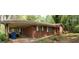 Charming brick home with a covered carport and mature landscaping in a tranquil setting at 8395 Rivertown Rd, Fairburn, GA 30213