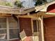 Damaged roof and door on a red brick home at 8395 Rivertown Rd, Fairburn, GA 30213