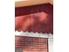 Damaged red siding is accented by a brick foundation at 8395 Rivertown Rd, Fairburn, GA 30213