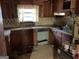 Outdated kitchen with wood cabinets and laminate countertops at 8395 Rivertown Rd, Fairburn, GA 30213