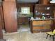 Dated kitchen with dark wood cabinets, laminate countertops, and outdated appliances at 8395 Rivertown Rd, Fairburn, GA 30213