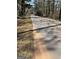 Asphalt road winds between wooded areas at 8395 Rivertown Rd, Fairburn, GA 30213