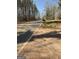 View of a rural road with mailbox in the foreground at 8395 Rivertown Rd, Fairburn, GA 30213