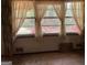 Window with sheer curtains and natural light into a room with dirty carpet at 8395 Rivertown Rd, Fairburn, GA 30213