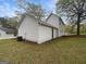 A spacious backyard with a lush lawn and mature trees providing shade and privacy at 7747 Roundtree Xing, Riverdale, GA 30274