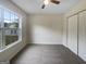 A carpeted bedroom featuring a window that allows natural light and a double-door closet at 7747 Roundtree Xing, Riverdale, GA 30274