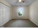 Simple bedroom featuring a large window and spacious closet at 7747 Roundtree Xing, Riverdale, GA 30274