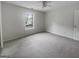 A bedroom with carpet flooring, a ceiling fan, and a bright window at 7747 Roundtree Xing, Riverdale, GA 30274