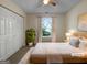 Cozy bedroom featuring a plush rug, a large window, and a spacious closet at 7747 Roundtree Xing, Riverdale, GA 30274