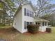 A two-story home with white siding, dark shutters, and a well-maintained lawn at 7747 Roundtree Xing, Riverdale, GA 30274