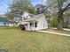 Charming two-story home with a landscaped front yard and a welcoming porch at 7747 Roundtree Xing, Riverdale, GA 30274