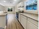 A bright kitchen with stainless steel appliances, granite countertops, and white cabinetry at 7747 Roundtree Xing, Riverdale, GA 30274