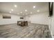 Finished basement with stylish wood-look floors and a central pool table offers ample space for recreation at 140 Wesley Pl, Fayetteville, GA 30214