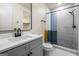 Modern bathroom featuring a gray vanity with white countertop and a walk-in shower with a colorful curtain at 140 Wesley Pl, Fayetteville, GA 30214