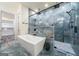 Modern bathroom featuring a glass-enclosed shower, soaking tub, and beautiful blue tile at 140 Wesley Pl, Fayetteville, GA 30214