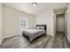 Clean bedroom with stylish laminate flooring, a large window and neutral paint at 140 Wesley Pl, Fayetteville, GA 30214