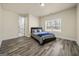 Bright bedroom features wood-look flooring and a window with natural light at 140 Wesley Pl, Fayetteville, GA 30214