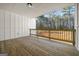 Relaxing covered deck with wood railing and views of the lush trees at 140 Wesley Pl, Fayetteville, GA 30214