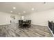 Dining area with a dark wood table and seating for eight, with gray wood floors at 140 Wesley Pl, Fayetteville, GA 30214