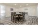 Dining room featuring a dark wood table with seating for eight and gray wood floors at 140 Wesley Pl, Fayetteville, GA 30214