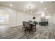 Open concept dining area with light wood floors, living room access, and a modern dining table at 140 Wesley Pl, Fayetteville, GA 30214