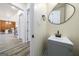 Stylish half bathroom with a modern sink, black fixtures, and decorative mirror at 140 Wesley Pl, Fayetteville, GA 30214